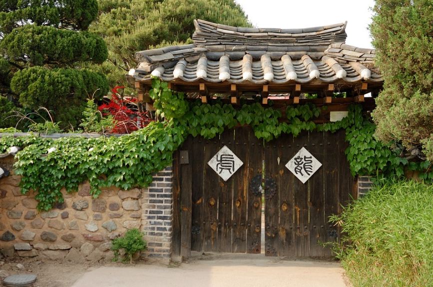 wooden doors, stone walls, roof tiles, plants, trees, signages