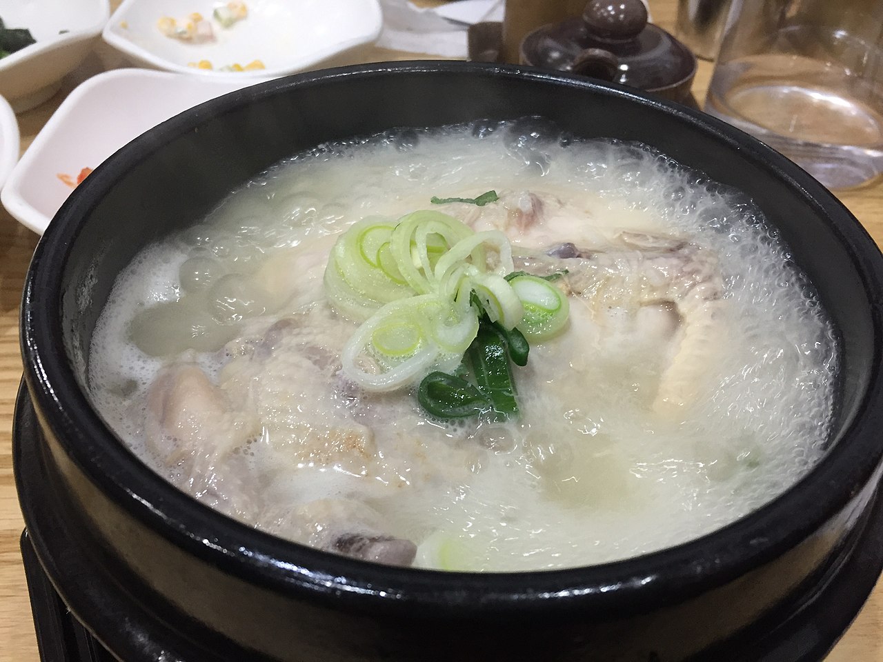 Image of hot sizzling Ginseng chicken soup (samgyetang).