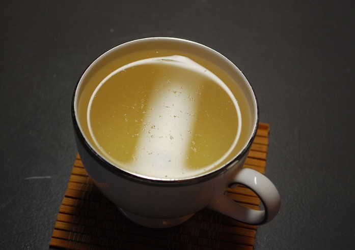 white tea in a cup with white hairs on the surface