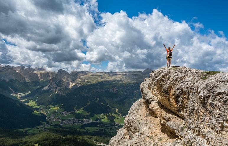 Picture of a woman at the top of a mountain