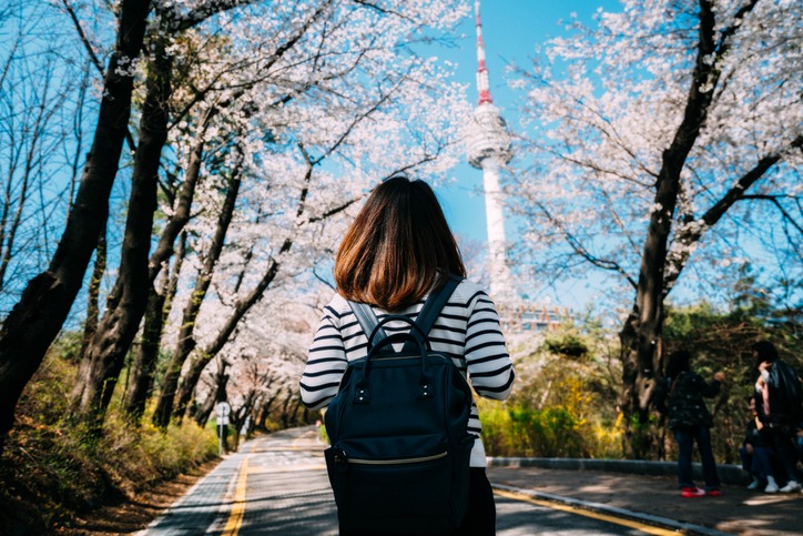 Young woman traveler backpacker traveling into N Seoul Tower at Namsan Mountain in Seoul City, South Korea