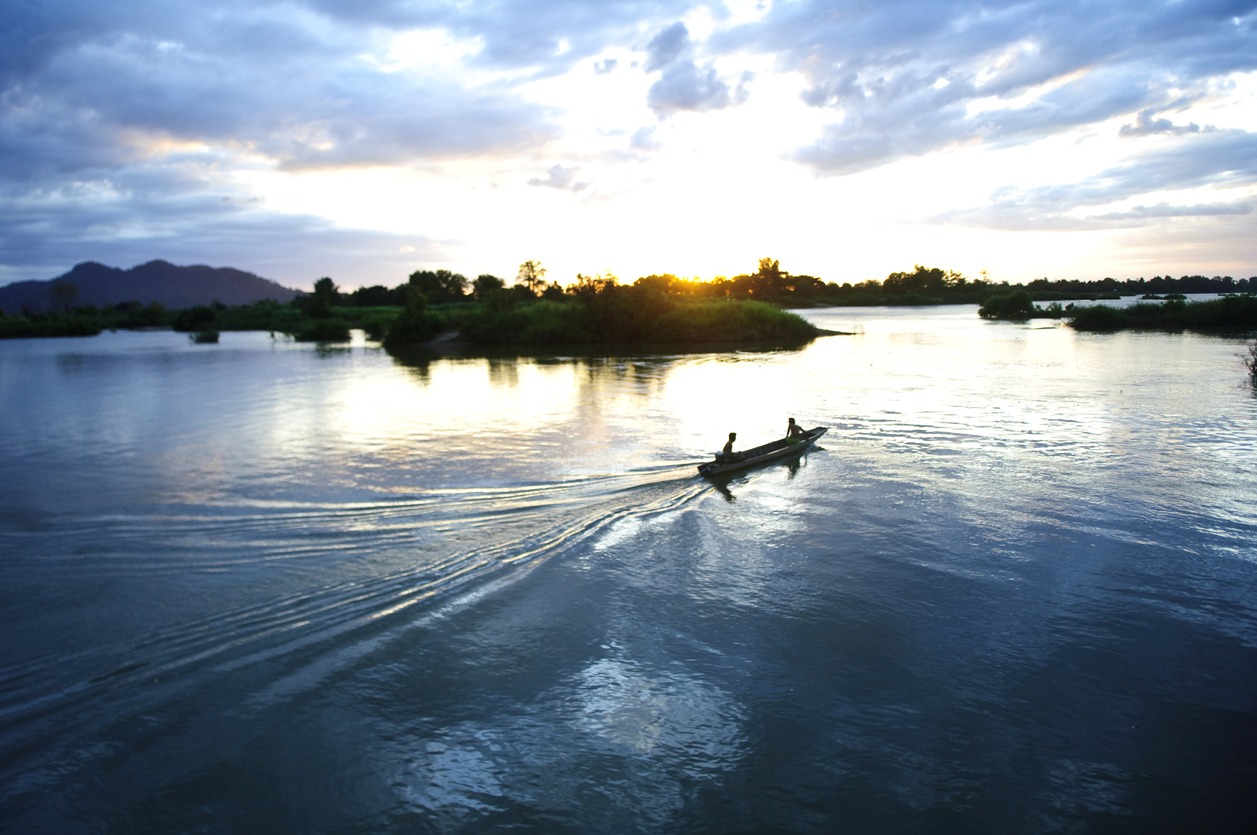 boat on the mekong river by sunset, don det, 4000 islands, laos