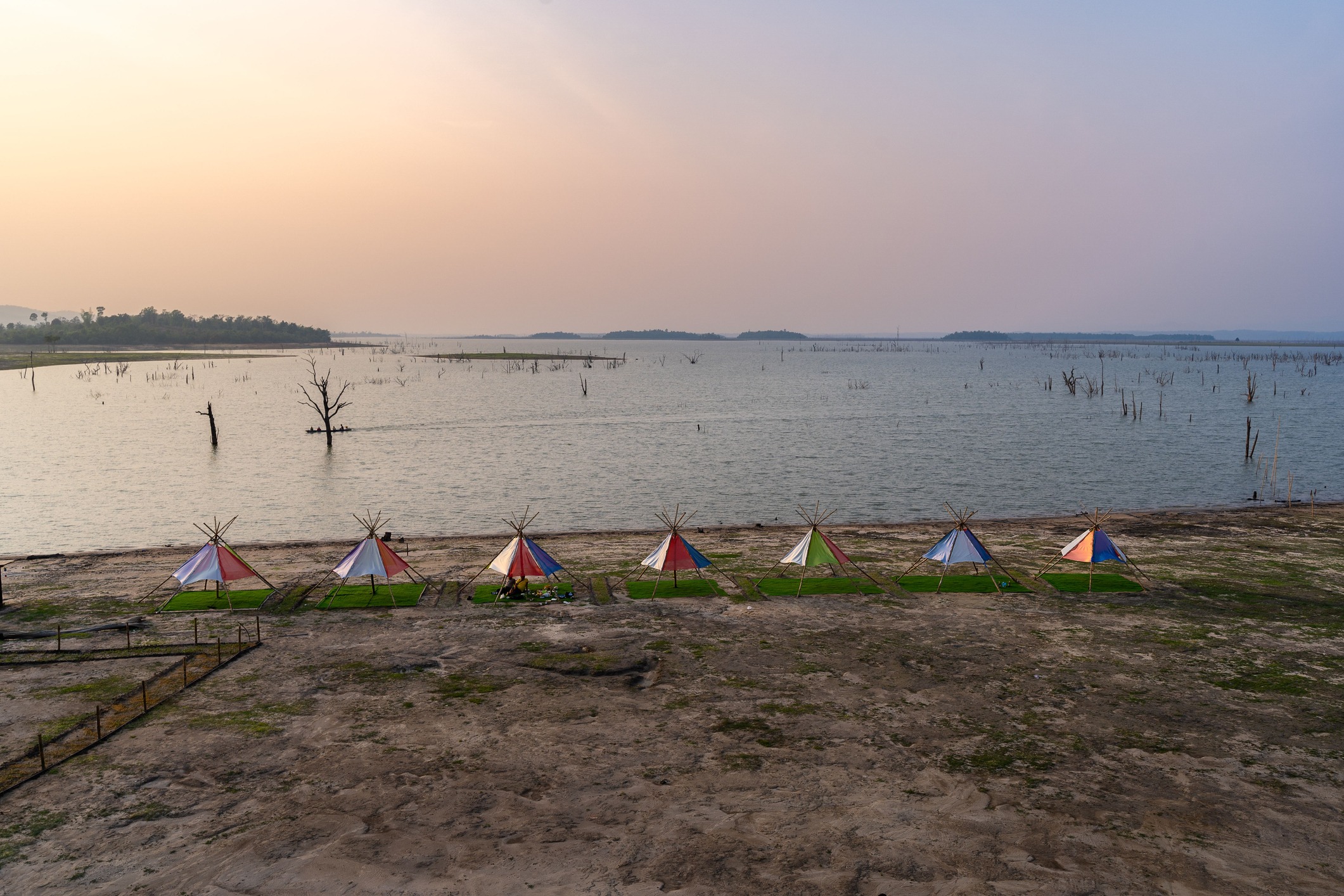 Scenic view of tents on the shore of Falang Lake (Thakhek loop), Laos at sunset